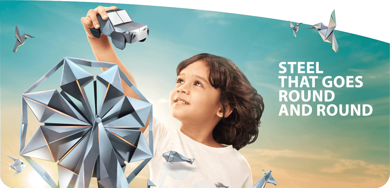 Child holding an origami car in Tata Steel 'Steel That Goes Round and Round' scene