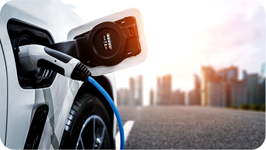 White electric car charging at a Tata Steel plant